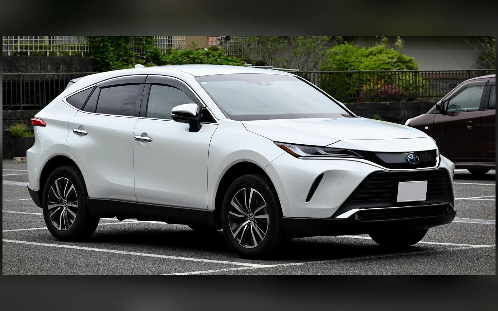 White Toyota Harrier-class executive 4x4, front three-quarter view