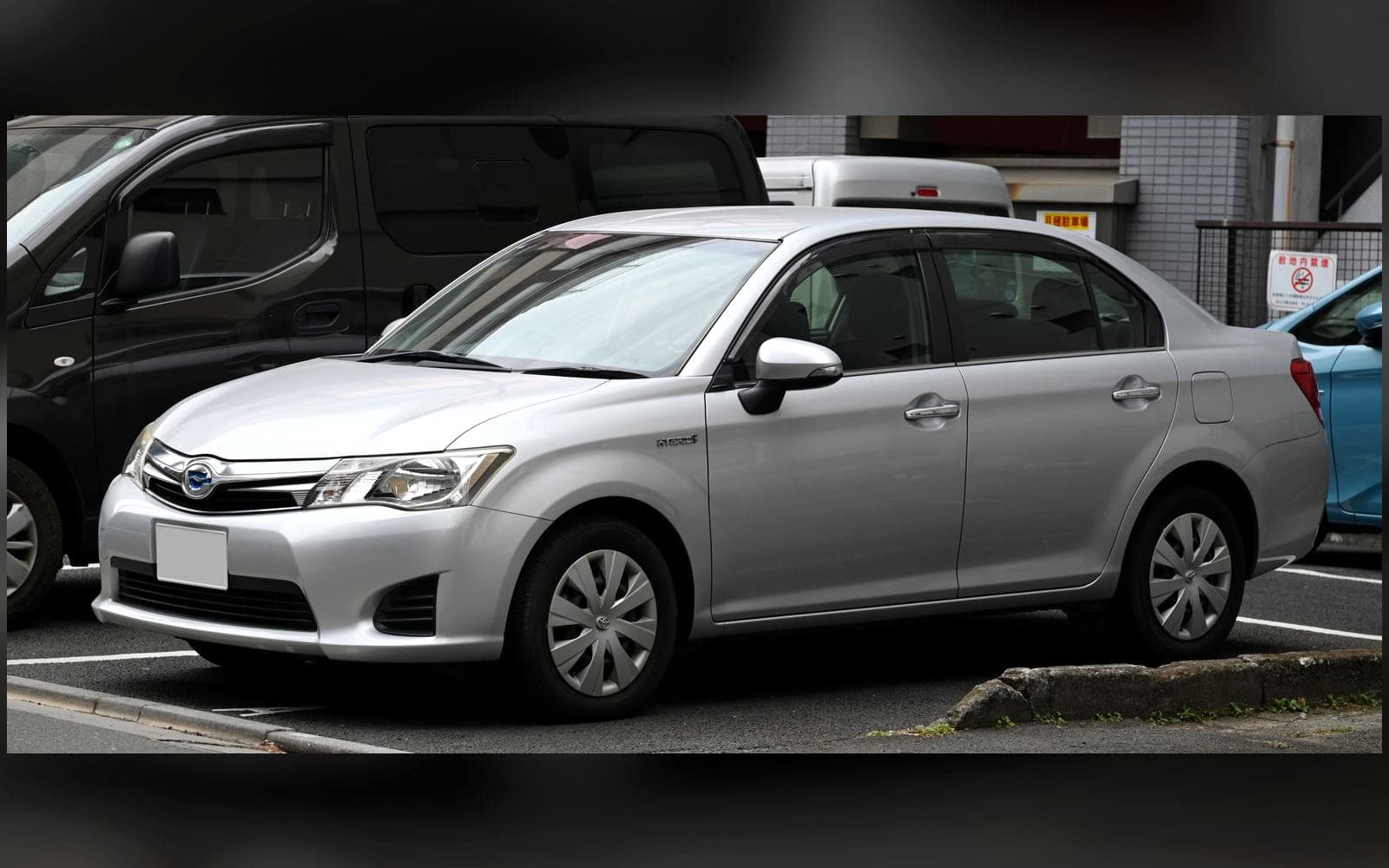 Silver Toyota Corolla Axio-class executive saloon, front three-quarter view