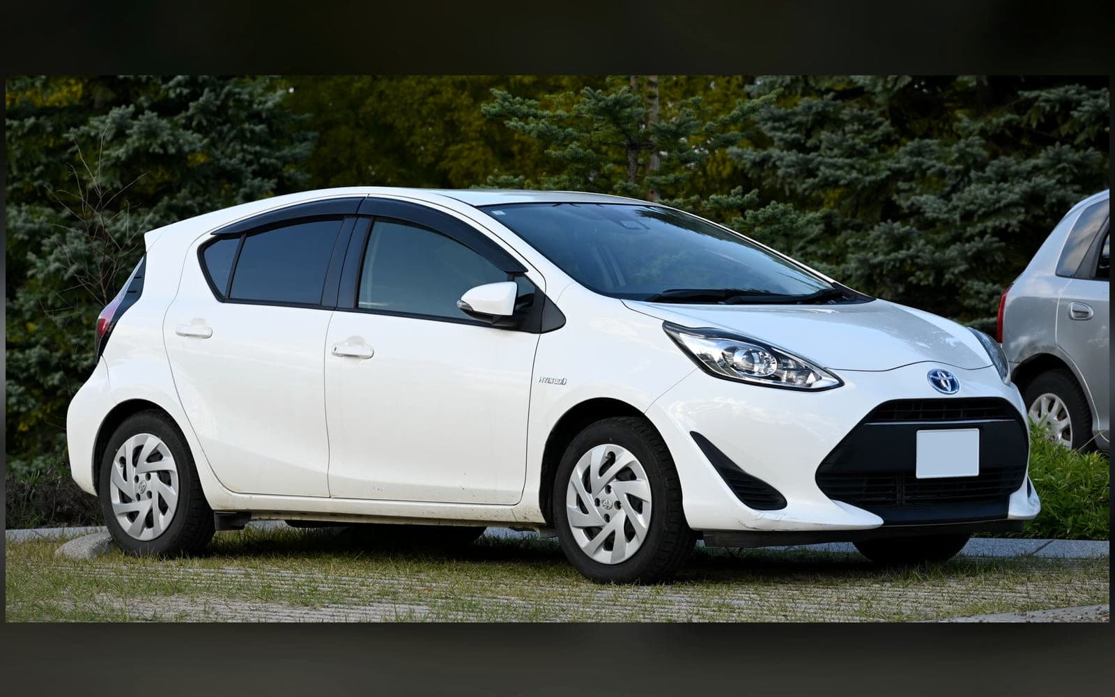 White Toyota Aqua-class hatchback, front three-quarter view