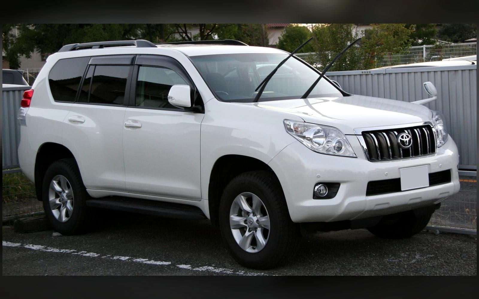 White Toyota Land Cruiser Prado-class luxury 4x4, front three-quarter view