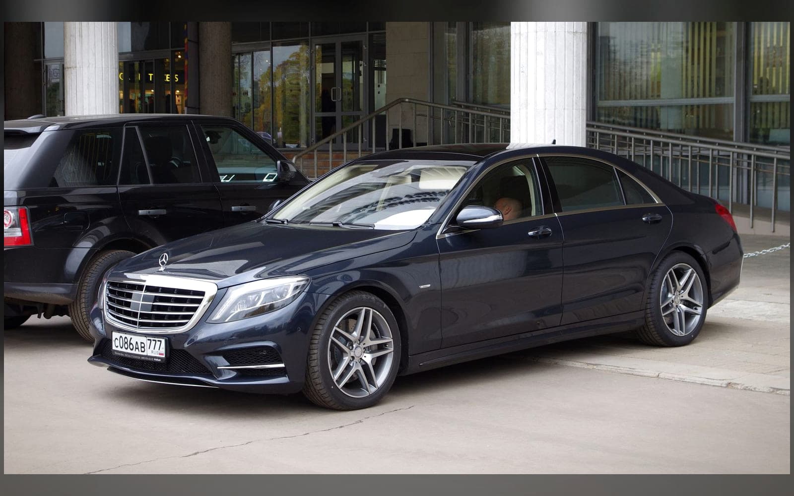 Black Mercedes-Benz S-Class luxury saloon parked kerbside