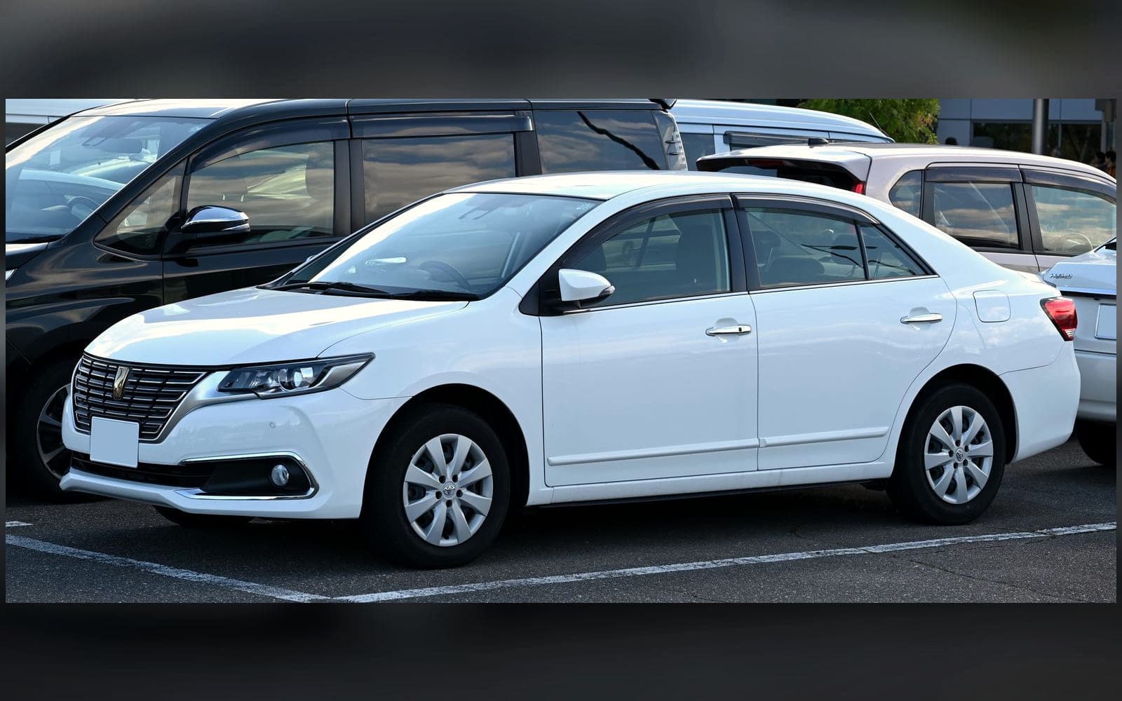 White Toyota Premio-class premium saloon, front three-quarter view