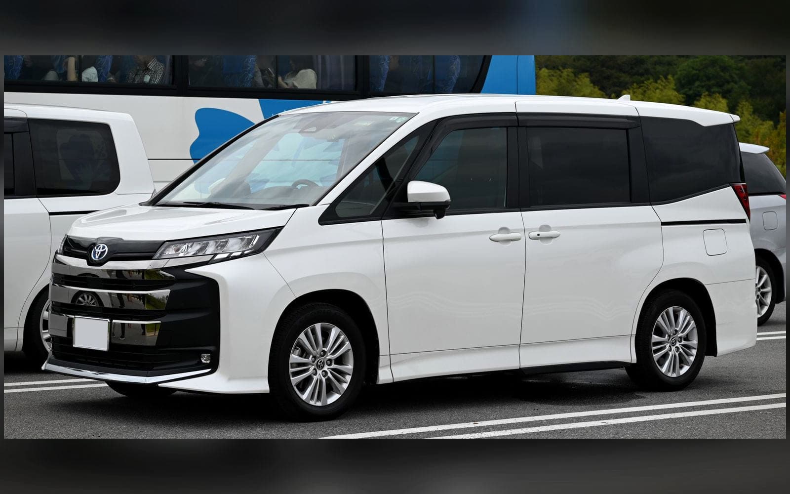 White Toyota Noah-class seven-seat MPV showing the sliding side door