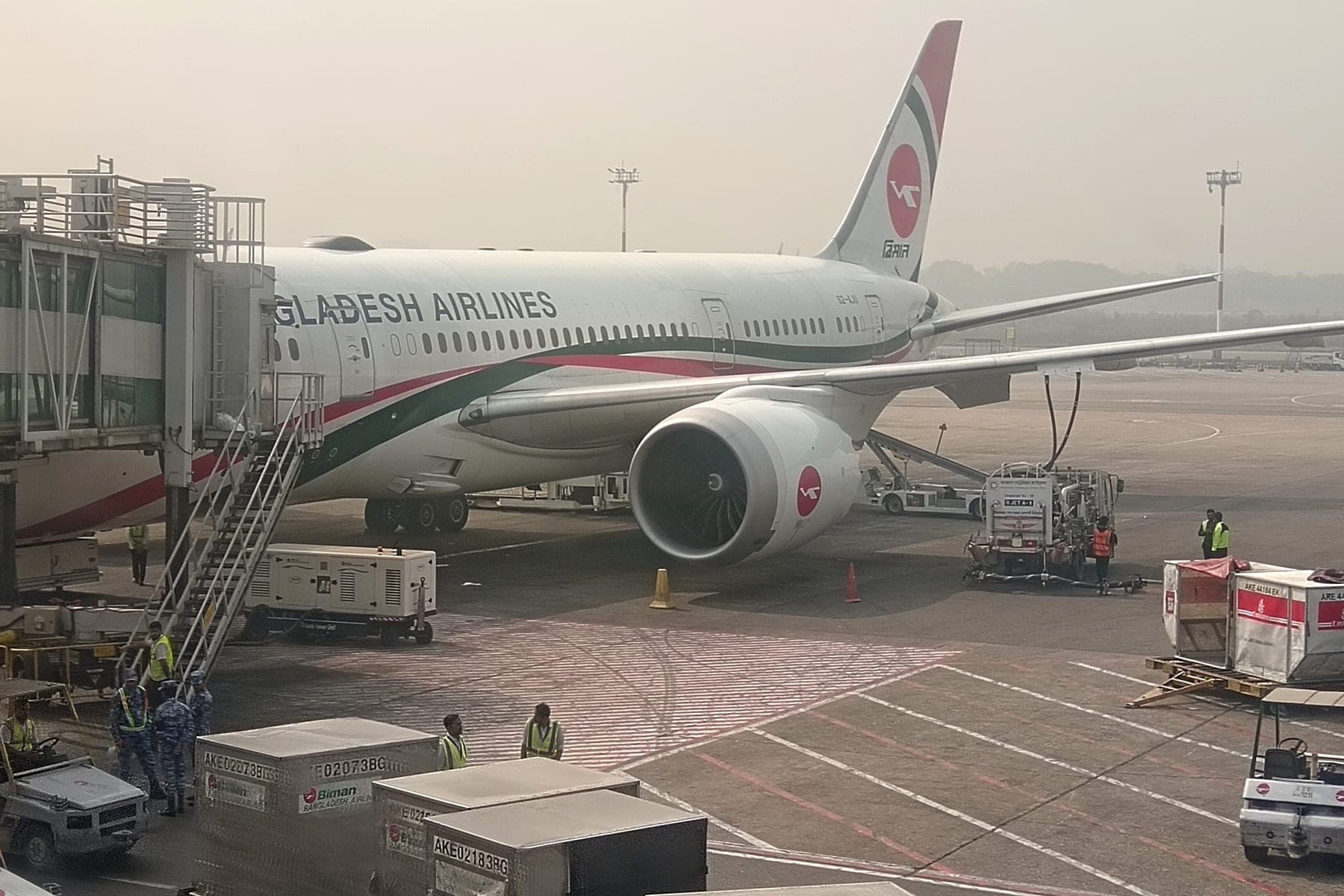 A Biman Bangladesh Airlines aircraft at a boarding bridge in Dhaka