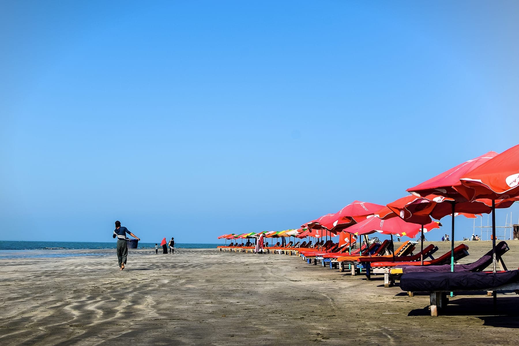 Beach umbrellas along the shore at Cox's Bazar